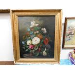 A framed oil painting of floral still life signed