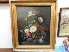 A framed oil painting of floral still life signed