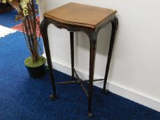 A 19thC. style mahogany plant stand with carved shoulders & turned stretchers