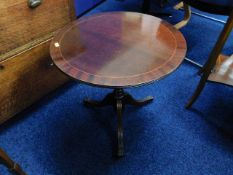 A circular low level mahogany table with brass fee