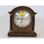 A small early 20thC. wooden mantle clock