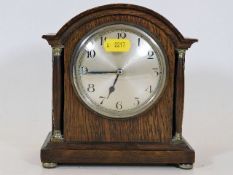A small early 20thC. wooden mantle clock