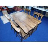 A farmhouse style trestle table with four chairs