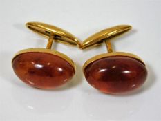 A pair of yellow metal amber cufflinks with Russia