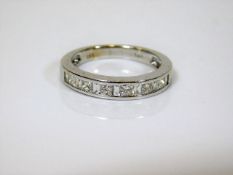 A 14ct white gold half eternity ring set with bagu