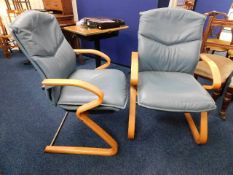A pair of leather retro style armchairs