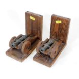 A pair of small mounted cannons as bookends