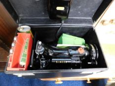 A small electric Singer sewing machine with case &