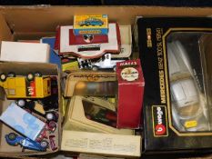 A box of diecast vehicles, some boxed