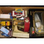 A box of diecast vehicles, some boxed