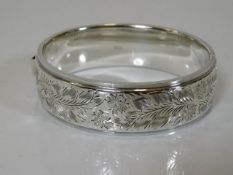 A vintage silver bangle with chased decor