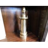 A brass trench art style lighthouse