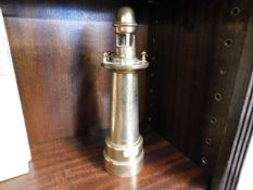 A brass trench art style lighthouse