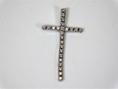 An 18ct white gold articulated cross set with diam