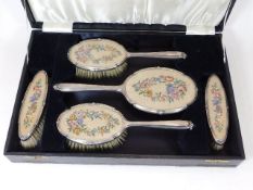 A five piece silver mounted dressing table set wit