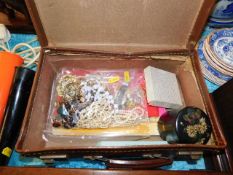 A small travel case, a quantity of costume jewelle