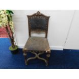 A 19thC. continental oak chair with embossed crest