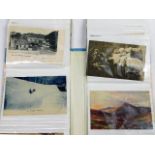 A mixed album of vintage postcards