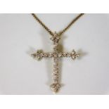 An 18ct gold & diamond cross with chain 5.7g