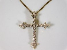 An 18ct gold & diamond cross with chain 5.7g