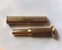 A 9ct gold cigar piercer with gold outer sleeve