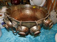 An antique silver on copper punch bowl with cups