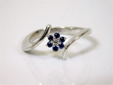 An 18ct white gold ring with daisy shaped diamond