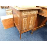 A small cabinet with carved double doors