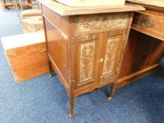 A small cabinet with carved double doors