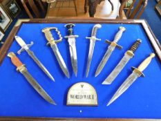 A mounted set of reproduction WW2 daggers