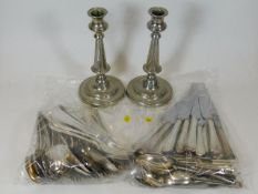 A pair of silver plated candlesticks twinned with