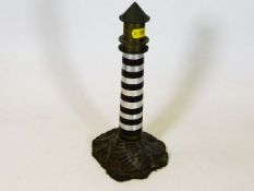 A brass & steel model of a lighthouse