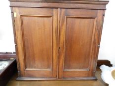 An antique mahogany wall cabinet