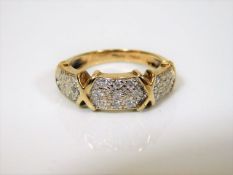 A 9ct gold ring set with nine diamonds on each pan