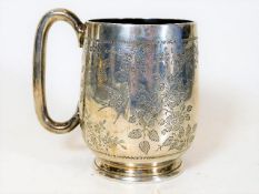A silver christening mug with chased bird & foliag