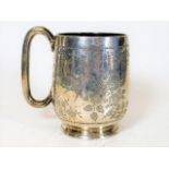 A silver christening mug with chased bird & foliag