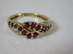 A 9ct gold ring set with garnet & small diamonds 2