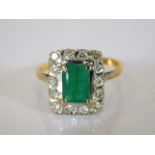 An 18ct gold ring set with emerald & diamonds 4.9g