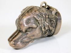 A silver vesta case in the form of a dog with small applied enamelled Jersey crest on rear