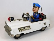 A tin plate toy police car