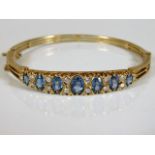 A fine antique style 9ct gold bangle set with approx. 5ct sapphire & 0.6ct diamond 14.8g