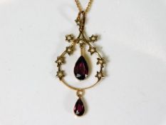 An early 20thC. garnet & pearl pendant with chain