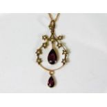 An early 20thC. garnet & pearl pendant with chain