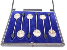 A cased set of silver coffee bean spoons