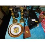 A pair of binoculars, a set of decorative plates & a camera