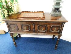 A 1920's Gothic style oak sideboard with two drawe
