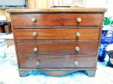 An antique apprentice piece style chest of drawers