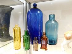 A large blue poison bottle & other bottles