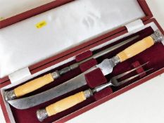 An antique carving set with ivory handles & silver