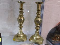 A pair of large Good Luck brass candlesticks
